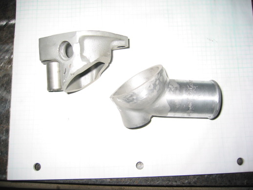 Pieces from Ford and Mazda thermostat housings